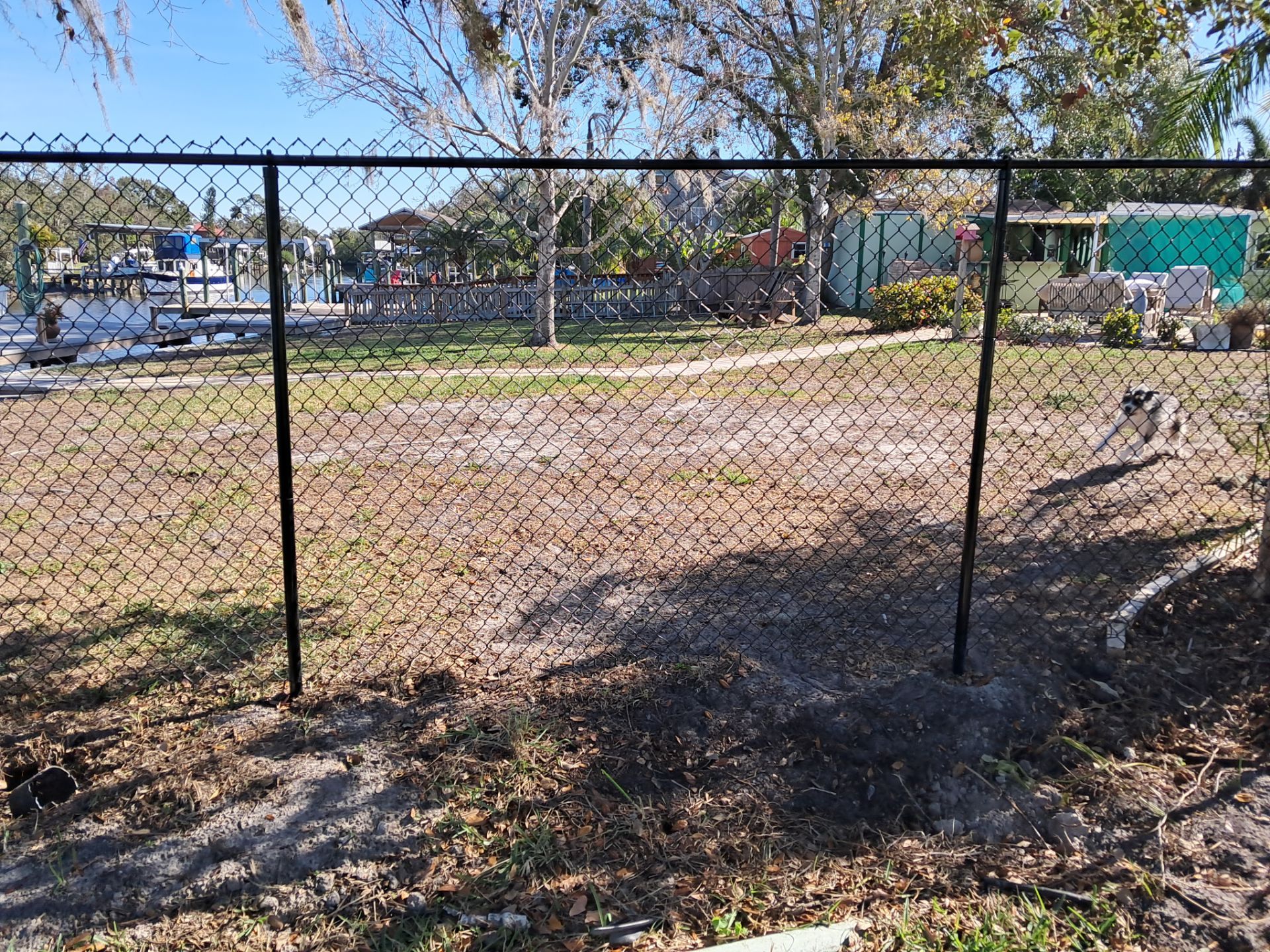 Black Vinyl Chain-link Fence Installation by All American Fence